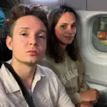 Two passengers (Sammy on the right, Raiff on the left) seated next to a cabin window on an EasyJet flight that was stuck on the tarmac.