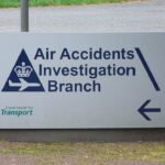 A white sign that reads "Air Accidents Investigation Branch" in dark blue.