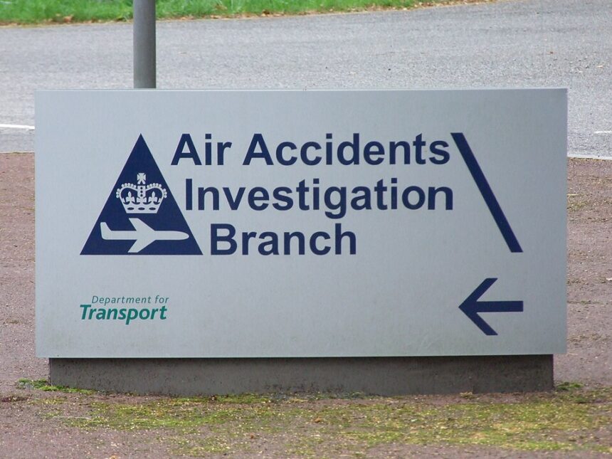A white sign that reads "Air Accidents Investigation Branch" in dark blue.