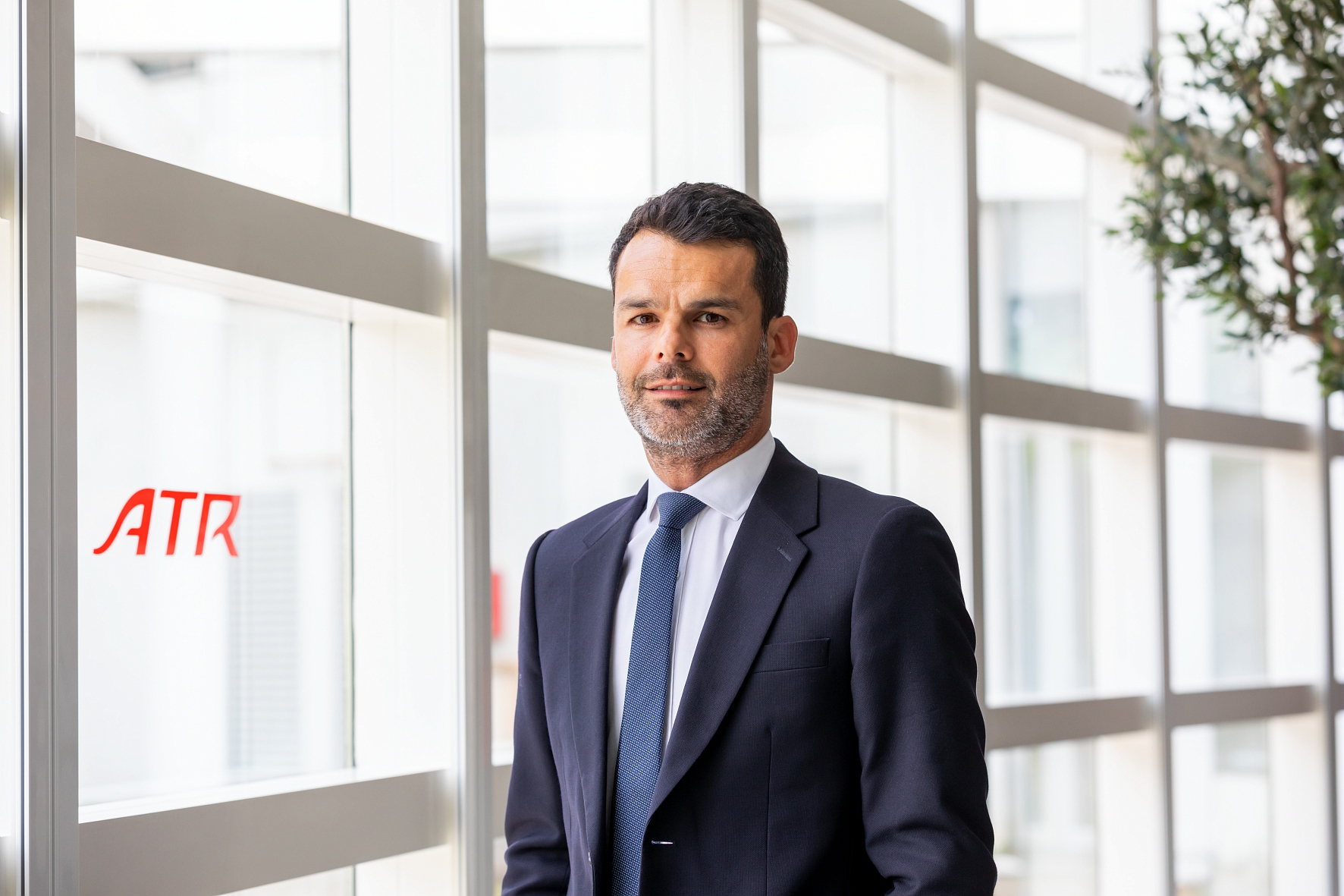 Alexis Vidal, Chief Commercial Officer at ATR, standing in an office corridor with the ATR logo visible in the background.