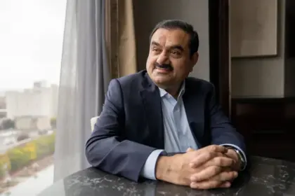 Gautam Adani looks pensive as he stares out the window with his hands interlocked on the table.