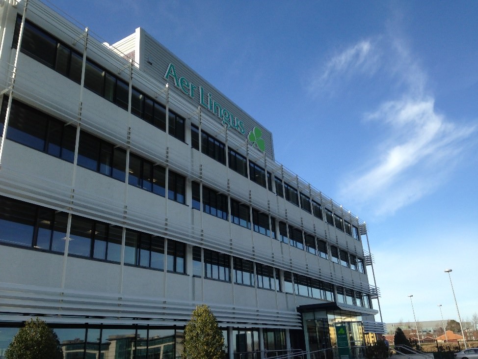 Aer Lingus Head Office building at Dublin Airport (DUB) against a clear blue sky.