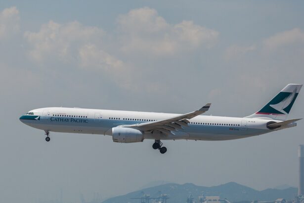 A Cathay Pacific Airbus aircraft taking off at Hong Kong International Airport. Cloudy sky in the background.