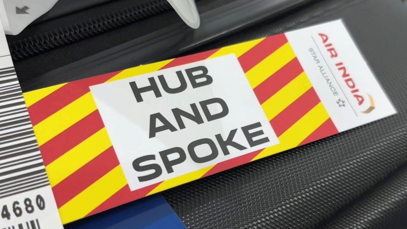Air India 'Hub and Spoke' sticker displayed on a piece of luggage.