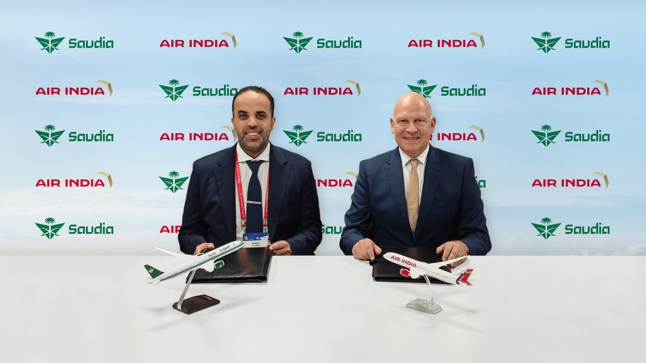 Photograph depicting the CEO of each airline seated next to each other; the airlines are Saudia and Air India, respectively.