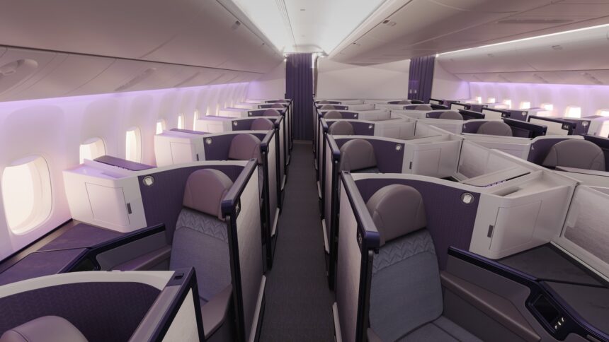 Aeroplane interior aisle view, with rows of Business class seats on either side