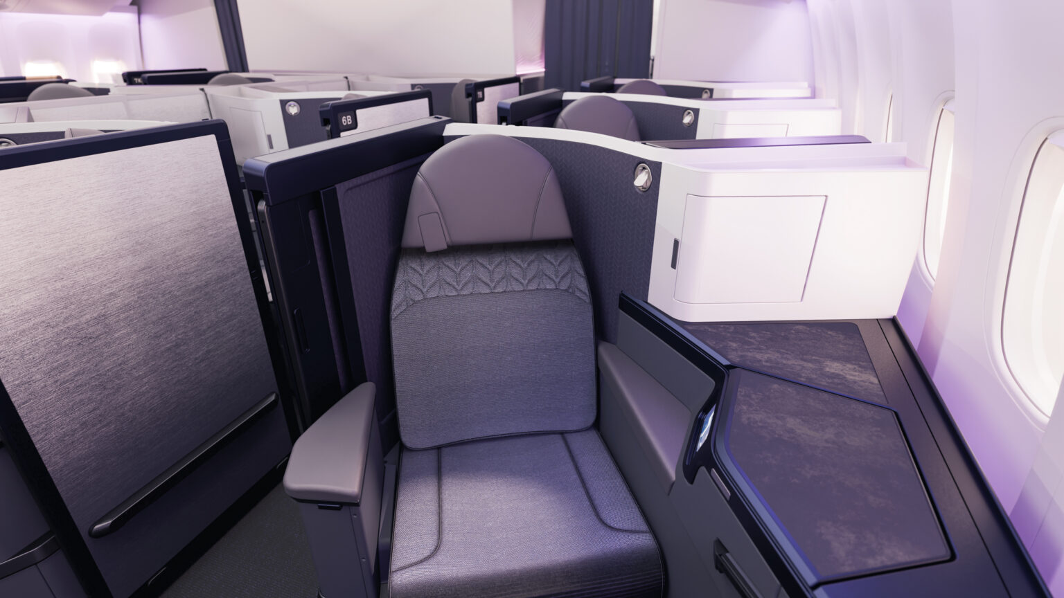 Aeroplane Business Premier class view from in front, with a comfortable looking chair, wall divider adn a table on the side, and daylight coming in from the window
