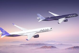 Two Riyadh Air Airbus A350-1000s flying side by side over some mountains