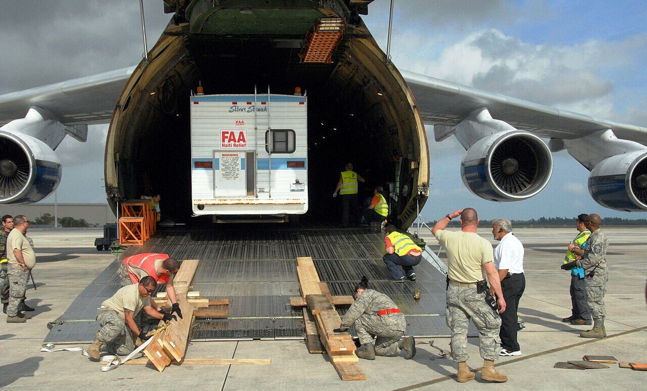 Military personnel load a mobile air traffic control tower onto an Antonov An-124 cargo aircraft at Homestead Air Reserve Base in Florida