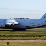 An Antonov An-124-100 heavy cargo aircraft sits on the runway preparing for takeoff at Manchester Airport, with its large fuselage