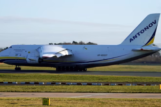An Antonov An-124-100 heavy cargo aircraft sits on the runway preparing for takeoff at Manchester Airport, with its large fuselage