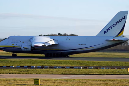 An Antonov An-124-100 heavy cargo aircraft sits on the runway preparing for takeoff at Manchester Airport, with its large fuselage