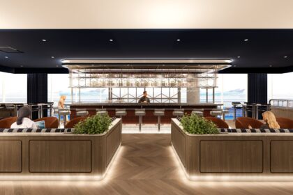 The British Airways' redesigned Newark lounge. A bar in the middle with booths on both sides.
