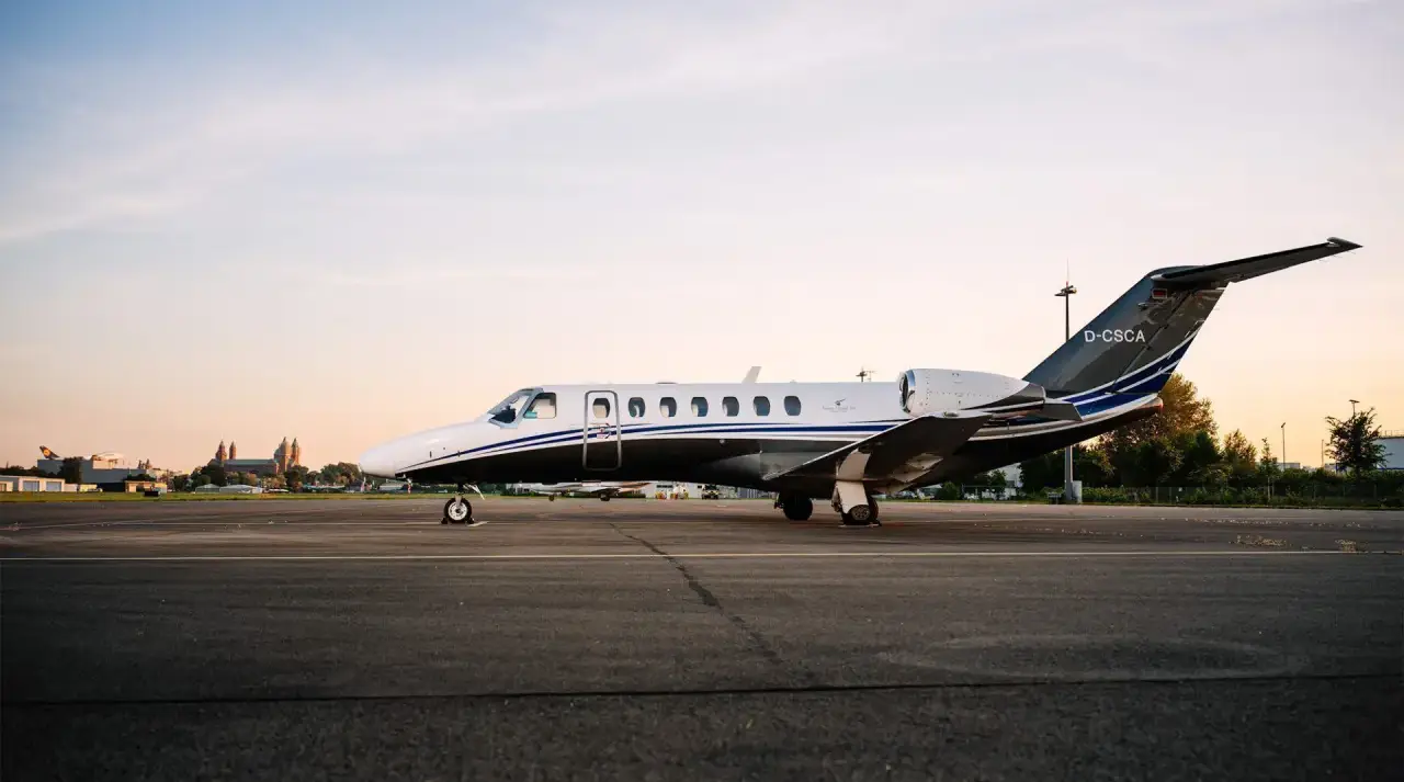 A Silver Cloud Air Cessna Citation Jet3, registration D-CSCA, on the tarmac. Trees visible in the background.