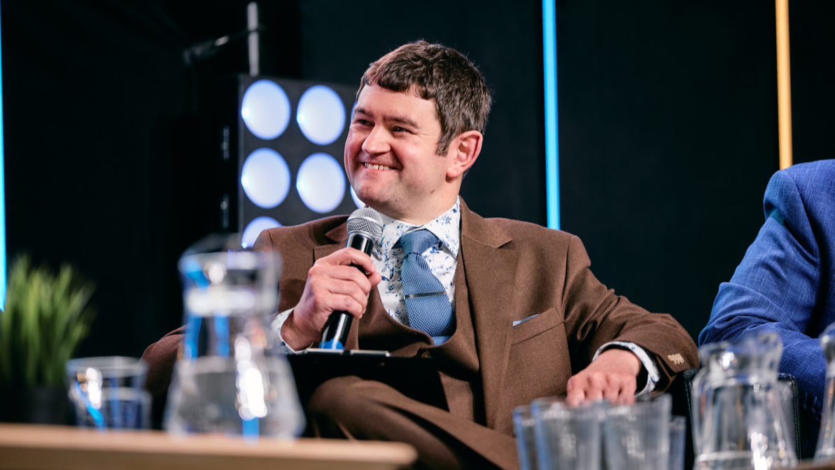 Dan Fell MBE, chief executive of Doncaster Chamber, photographed smiling while holding a microphone.