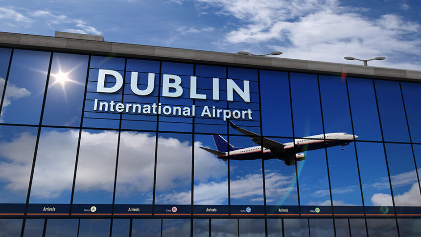 Pane taking off in the reflection of Dublin Airport windows.