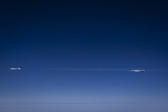 Image shows two Gulfstream 800 aircraft in a dark sky.