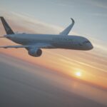 Image shows a Cathay Pacific A350-900 aircraft flying in a sunset