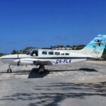 Cessna Aircraft C6-FLX on the tarmac; blue sky.