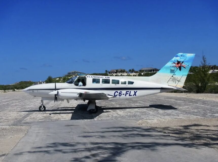 Cessna Aircraft C6-FLX on the tarmac; blue sky.