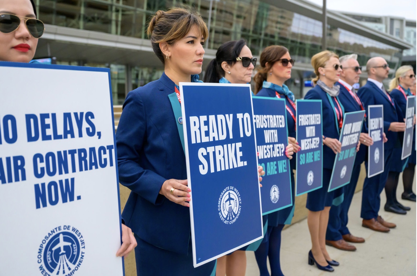 WestJet cabin crew’s strike action supported by the Canadian worker’s union ,standing in solidarity, holding placards whilst protesting.