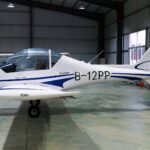 The blue and white B-12 PP plane, a Sunward Aurora SA60L, that would later be crashed by Liu, sat in a well-lit aircraft hanger.