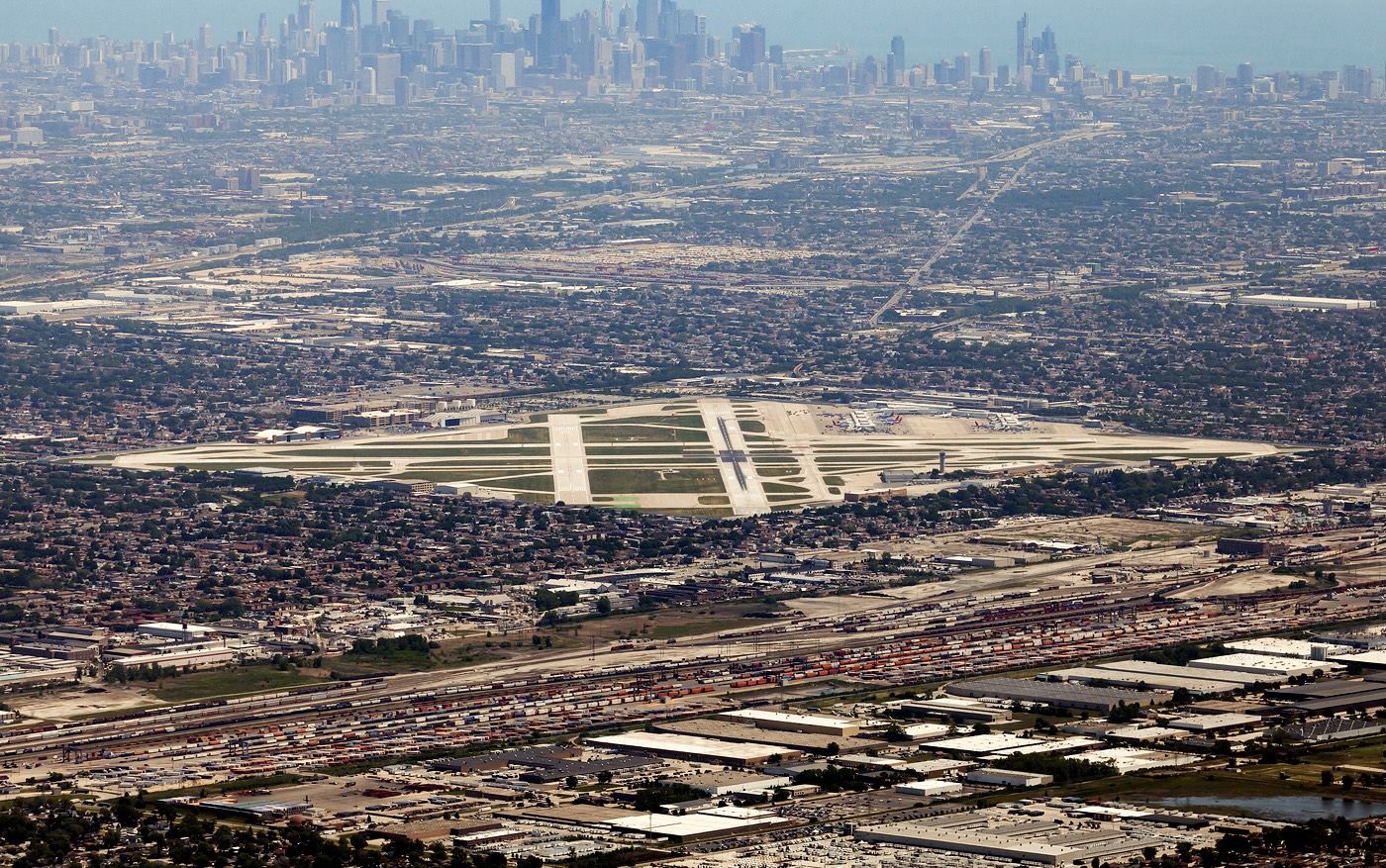 An aerial shot of Chicago Midway International Airport (MDW) on a sunny day, the city of Chicago can be seen in the background.