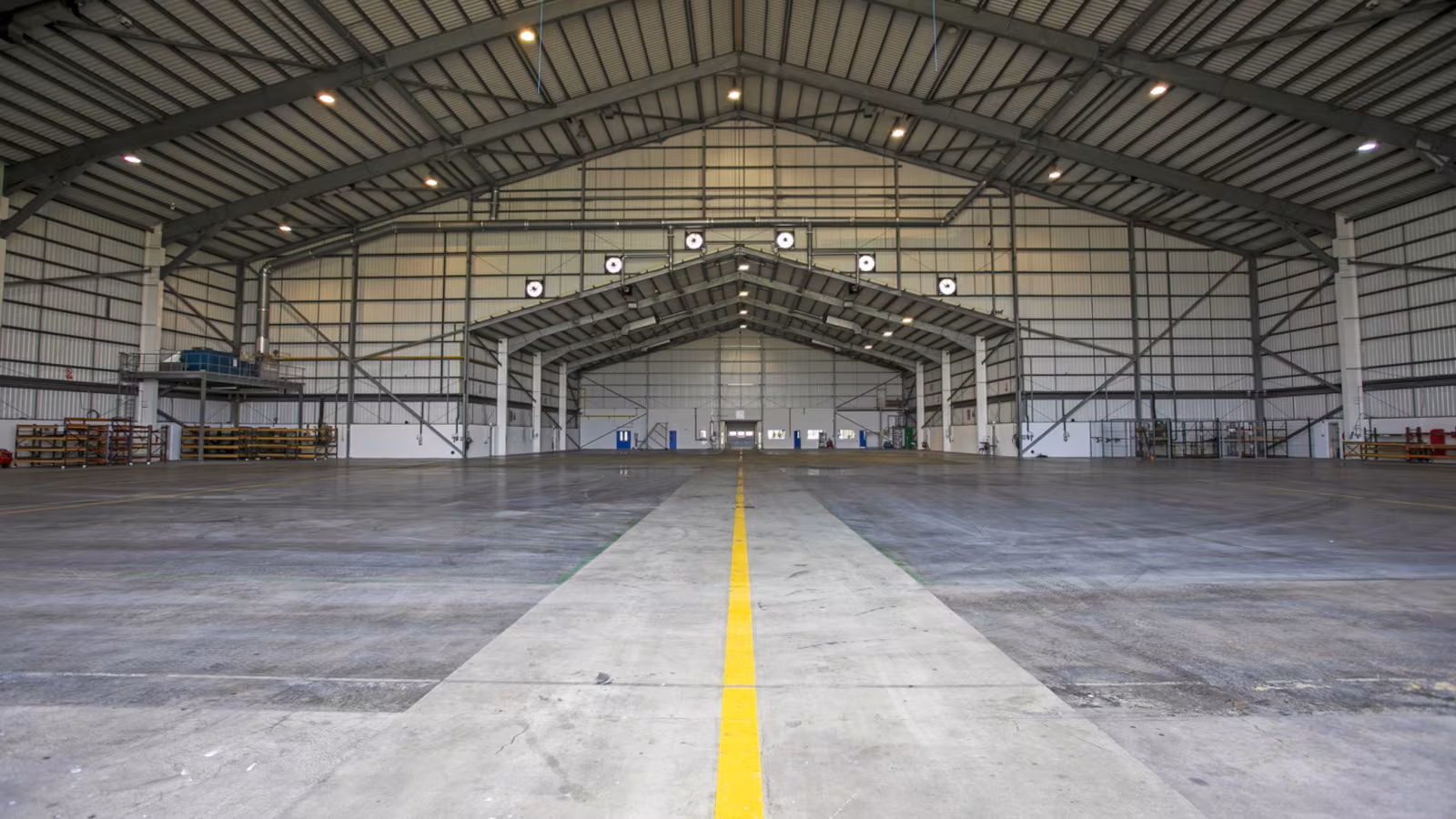 The inside of the existing Ryanair Hangar at Shannon Airport. A yellow line goes down the middle of the hangar.