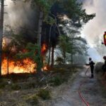 Smoke rises from the Fontainebleau forest as firefighters battle a major wildfire south of Paris