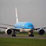 An image of a KLM aircraft taxing after landing on runway at Schiphol airport.