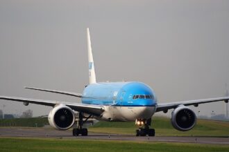 An image of a KLM aircraft taxing after landing on runway at Schiphol airport.