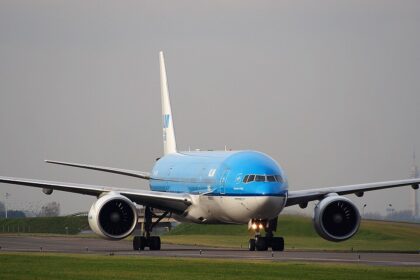 An image of a KLM aircraft taxing after landing on runway at Schiphol airport.