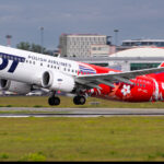 A LOT Polish Airlines Boeing 737 about to take off from a runway.