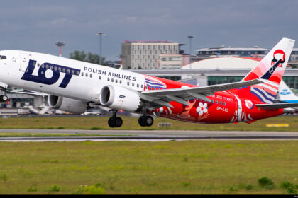 A LOT Polish Airlines Boeing 737 about to take off from a runway.