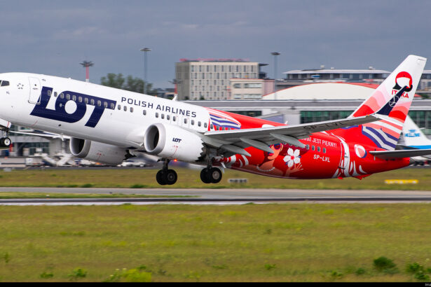 A LOT Polish Airlines Boeing 737 about to take off from a runway.