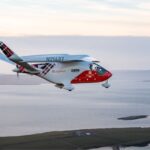 BETA’s ALIA electric aircraft shown midair, operating across Loganair’s network. The aircraft is decorated in the signature Loganair logo and tartan print.