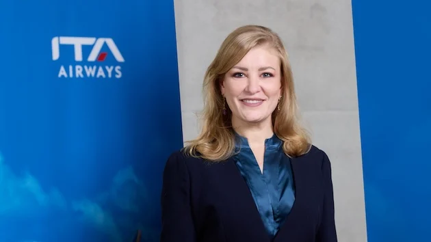 Lorenza Maggio poses against an ITA Airways background.