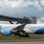 Norse Atlantic Boeing 787-9 Dreamliner registration G-CKOF, named 'Redwood,' taxiing past a terminal jet bridge at London Gatwick Airport.