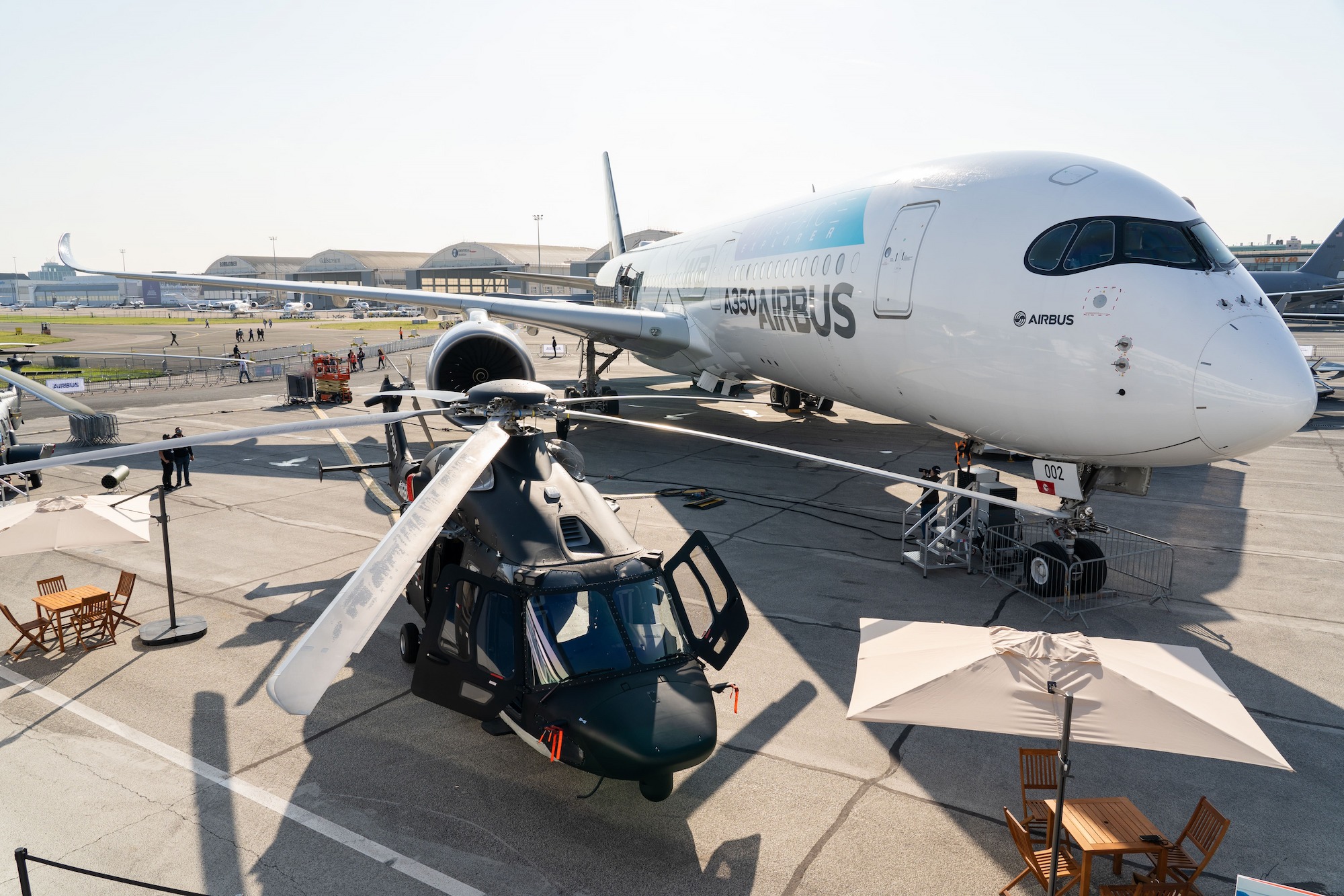 An Airbus A350-900 and an Airbus Helicopters H225M on static display at the 2023 Paris Airshow.