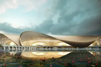 Architectural rendering of Navi Mumbai International Airport's terminal building with a lotus pond in the foreground.