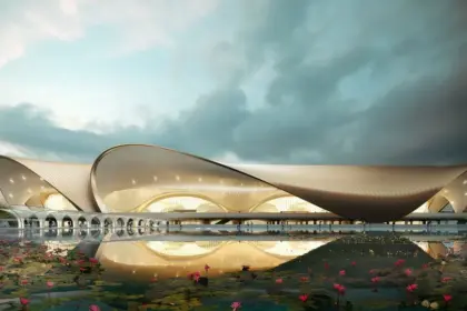 Architectural rendering of Navi Mumbai International Airport's terminal building with a lotus pond in the foreground.
