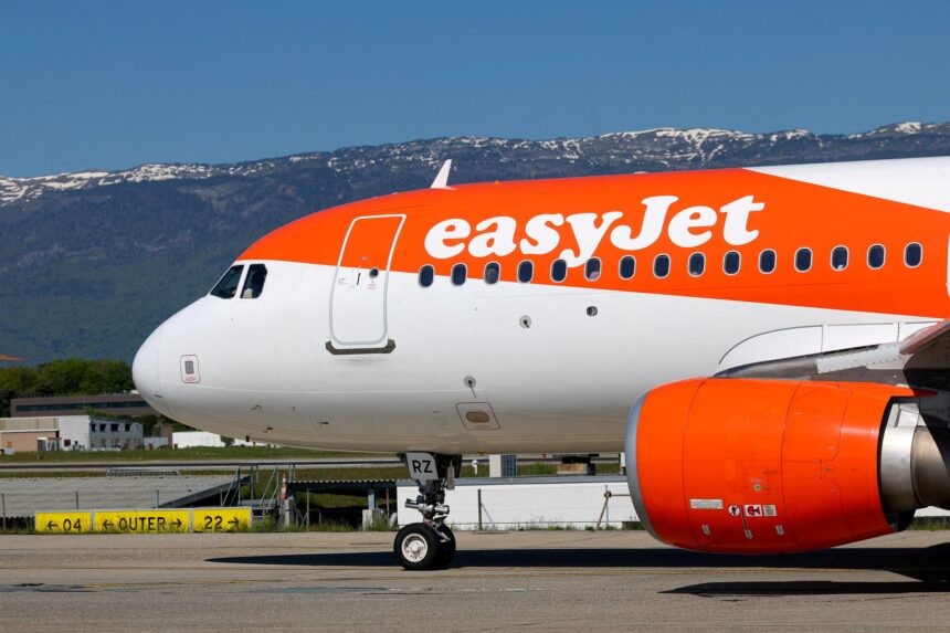 Side view of the front half of an Airbus A320 aircraft operated by easyJet on the ground.