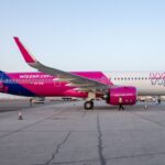 A side view of a Wizz Air a321-neo-7 plane waiting on the tarmac