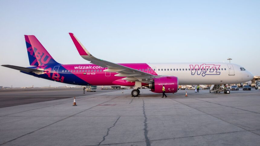A side view of a Wizz Air a321-neo-7 plane waiting on the tarmac