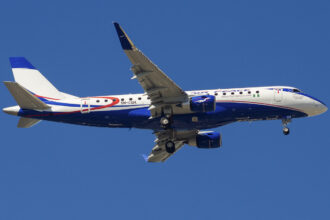 An Air Peace plane mid-flight, showing the bottom of the plane's fuselage and underside of its wings.
