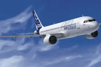 Airbus A320-neo flying through the clouds front side view. Branded with Airbus logos and colourways with a blue sky and clouds background.