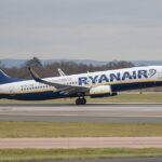 A Ryanair Boeing 737 that has landed and is parked on an airport runway.