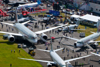 Birds Eye view of Farnborough airshow with multiple aircraft positioned on the ground for people to walk in and explore around