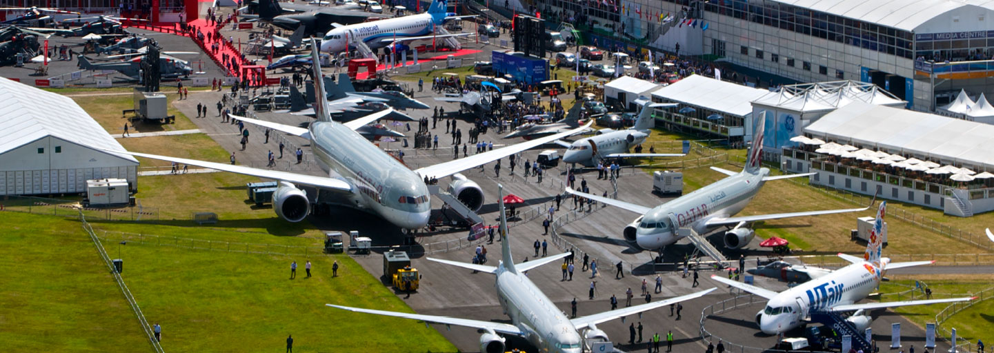 Birds Eye view of Farnborough airshow with multiple aircraft positioned on the ground for people to walk in and explore around