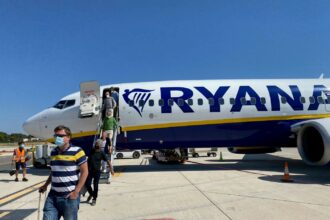 Ryanair jet landed on Mallorca tarmac with travelelrs leaving the plane and headed to the airport.